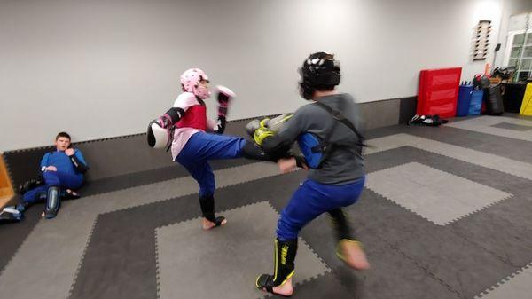 UJJ students practicing self-defense against strikes in Junior Sparring Class.