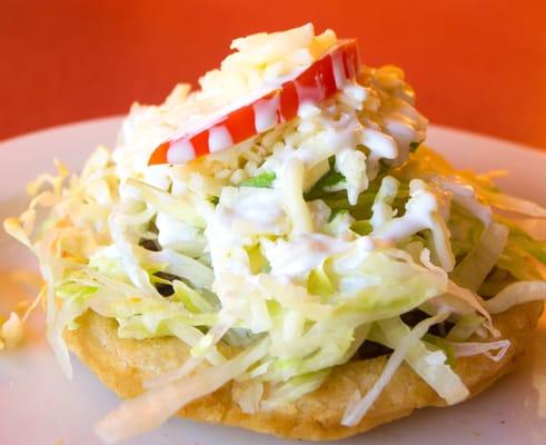 Chicken Sopes (deep fried corn patties topped with chicken and veggies)