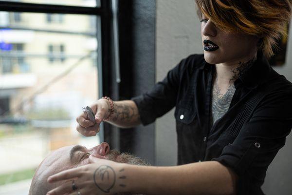 Our manager, Courtney, demonstrating a beard line up and shave.