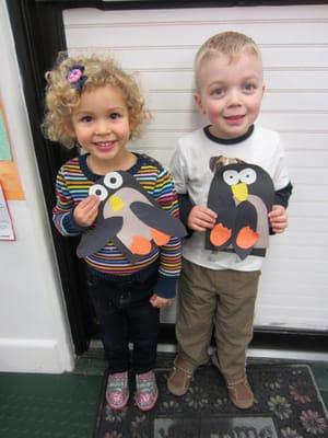 Proud PPA students displaying their "Letter P is for Penguin" art projects!