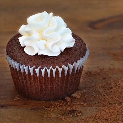 Chocolate cupcake topped with vanilla frosting