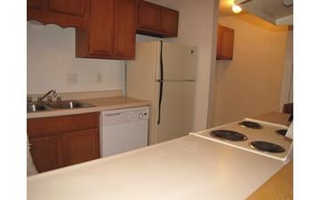 Another view of Westbury's kitchen, this one with a different layout. The appliances aren't new, but are well-maintained.