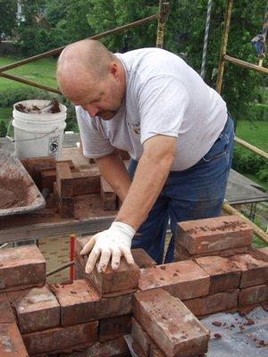 Gene Padgitt building an historic chimney