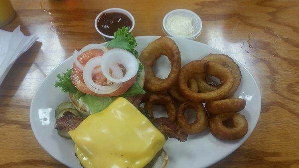 Juicy cheeseburger and crispy onion rings. Side of bbq and mayo