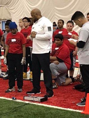 Coach Chad Hallett monitoring the 40 yd dash station at a youth football combine