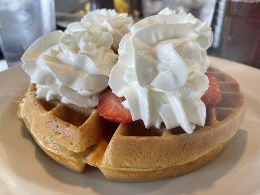 Waffle with strawberries and whip cream