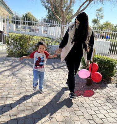 Little boy walking with help.