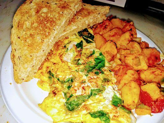 Espinach & turkey omelette with home fries and white toast.