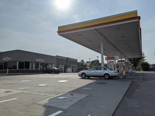 Outside the gas station, convenience store, and McDonald's. This filling station has eight pumps.