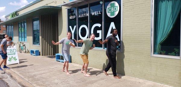 Store owners Steve and Todd doing the "Heisman" with Ricky Williams after he taught a CBD yoga class.