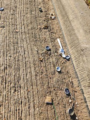 Beer Tops left in along sidewalk