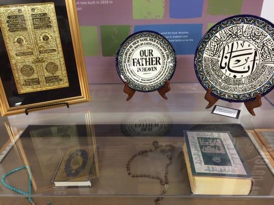 Quran and Bible in Arabic, different types of prayer beads, Islamic calligraphy on decorative plates