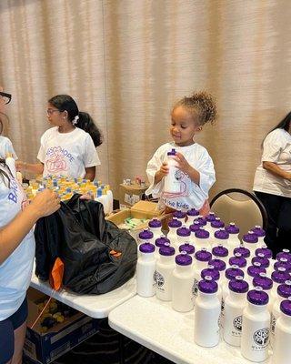 Filling Duffel bags with basic necessities for foster children