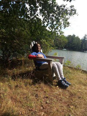 My kid relaxing next to the lake.