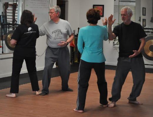 T'ai Chi students practicing "sticky hands" to train sensitivity.