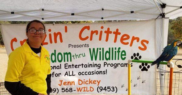 The critters and a volunteer at a festival.