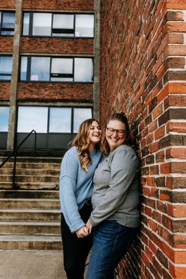 The couple poses outside of MHC by the dorm where they first met