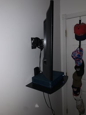 32" Tv mounted to a stud with a shelf below to keep the game close!