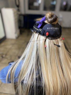 Stitching 1 row of hand-tied hair extensions