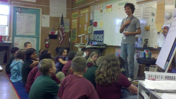 A volunteer giving a French lesson to third graders.