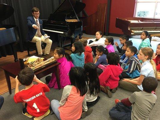 Sales Associate William works with young piano students for our educational program "Piano Inside & Out".