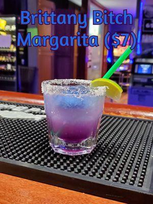 One of our August month specials with silver tequila, triple sec, lime juice, and color-changing butterfly pea tea ice cubes and syrup.