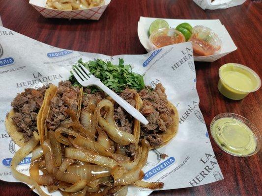 The double corn with mixed bistec and extra crispy tripa. Sauteed onions and cilantro on the side.