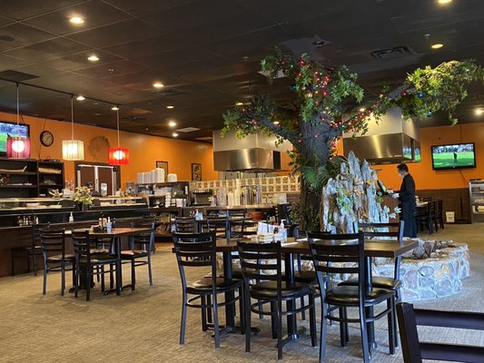 Inside of restaurant featuring the waterfall and hibachi in the back.