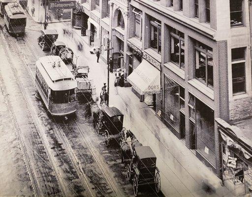 The Mercantile building 1910 with Straus Tobacconist on the left of the white awning in the center of the building.