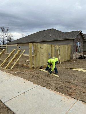 Wood fence going up in new subdivision in Van Buren