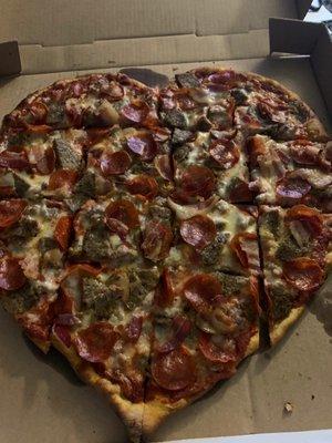 Heart shaped large meat lovers pizza