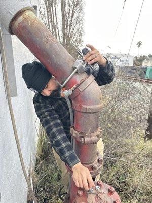 Carlos installing new flow switch on fire sprinkler riser