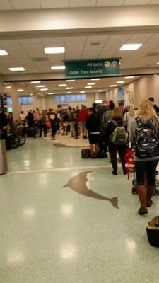 One ID checker, one conveyor belt open, at least ten employees lolly gagging around.