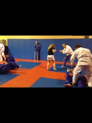 Auburn MMA Brazilian Jiu-Jitsu class - students learning "Stand Up Sweep"