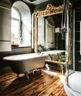 Stunning ornate mirror and claw tub goes so well with the modern dome shape glass shower. Selfies during bubble baths!