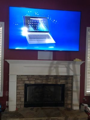 82" TV above fireplace.