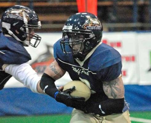 Running back Eric Donoval takes a handoff.