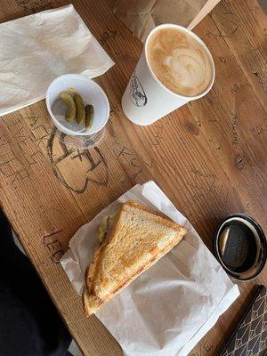 Turkey & Swiss grilled toastie with cornichons and an oatmilk latte