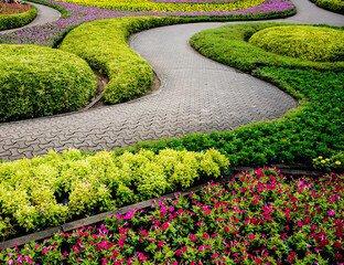 Walkway with pavers & landscaping with shrubs and seasonal flowers