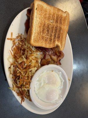 Poached eggs (cold), hashbrowns, bacon, and white bread