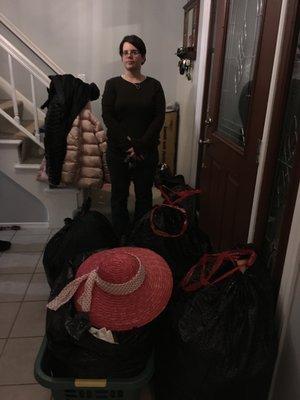 These clothes are for donation. My client took a picture of me by the bags she chose to donate. The bags are going out to the car.