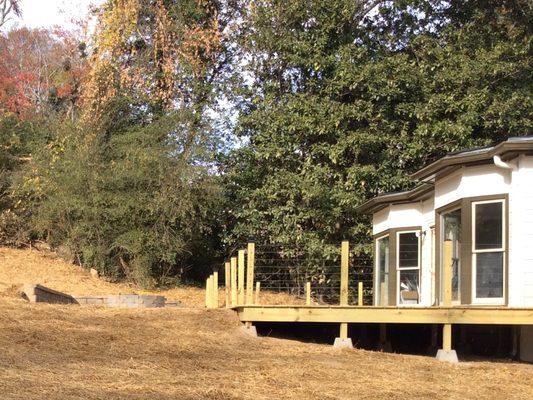 After picture of backyard makeover including irrigation, seed, deck installation and patio installation