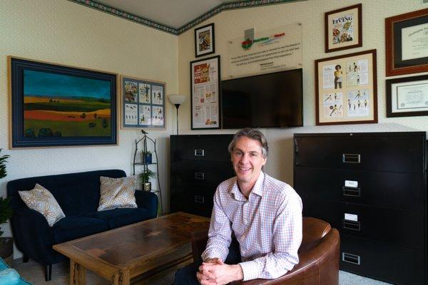 Michael, Owner of Nutrition with Heart, LLC. In His Office