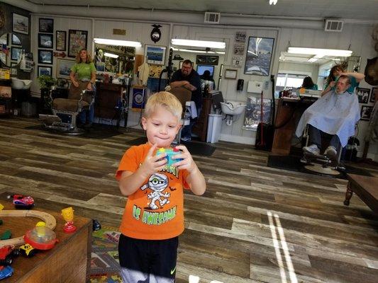 My son about to get his haircut at our favorite   barbershop