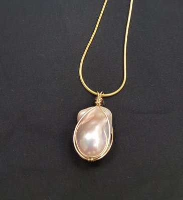 Baroque cultured pearl set in a graceful wire wrap setting.