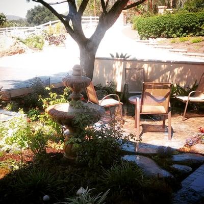 Stamped concrete patio area. Mike removed several trees and water using plants, and pruned the tree to provide the most shade.