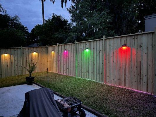 Wooden 8' privacy fence with solar lighting installed.