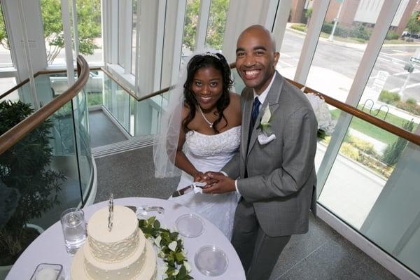 A happy couple cuts their cake in the Pavilion