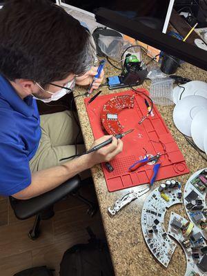 Ryan is soldering new resistors onto actuators that go on wellheads in the field. Interesting stuff!