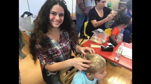 Doing a lice check at a preschool.